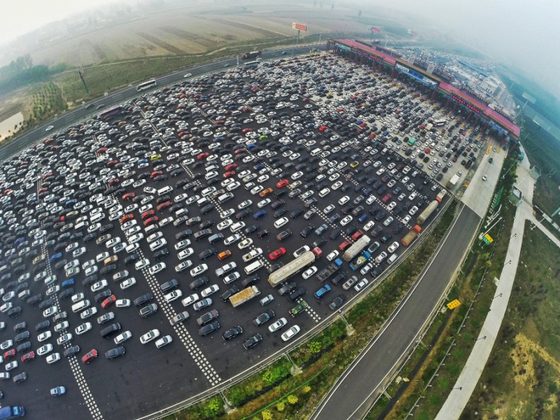 BEIJING, CHINA - OCTOBER 06:  (CHINA OUT) (EDITORS NOTE: Image captured with a fisheye lens) Aerial view of cars queuing up to pass a checkpoint set recently in the direction of Beijing on the Beijing-Hong Kong-Macau Expressway at the end of National Day Holiday on October 6, 2015 in Beijing, China. A travel peak appeared at the end of 7-day China's National Day Holiday.  (Photo by ChinaFotoPress/ChinaFotoPress via Getty Images)